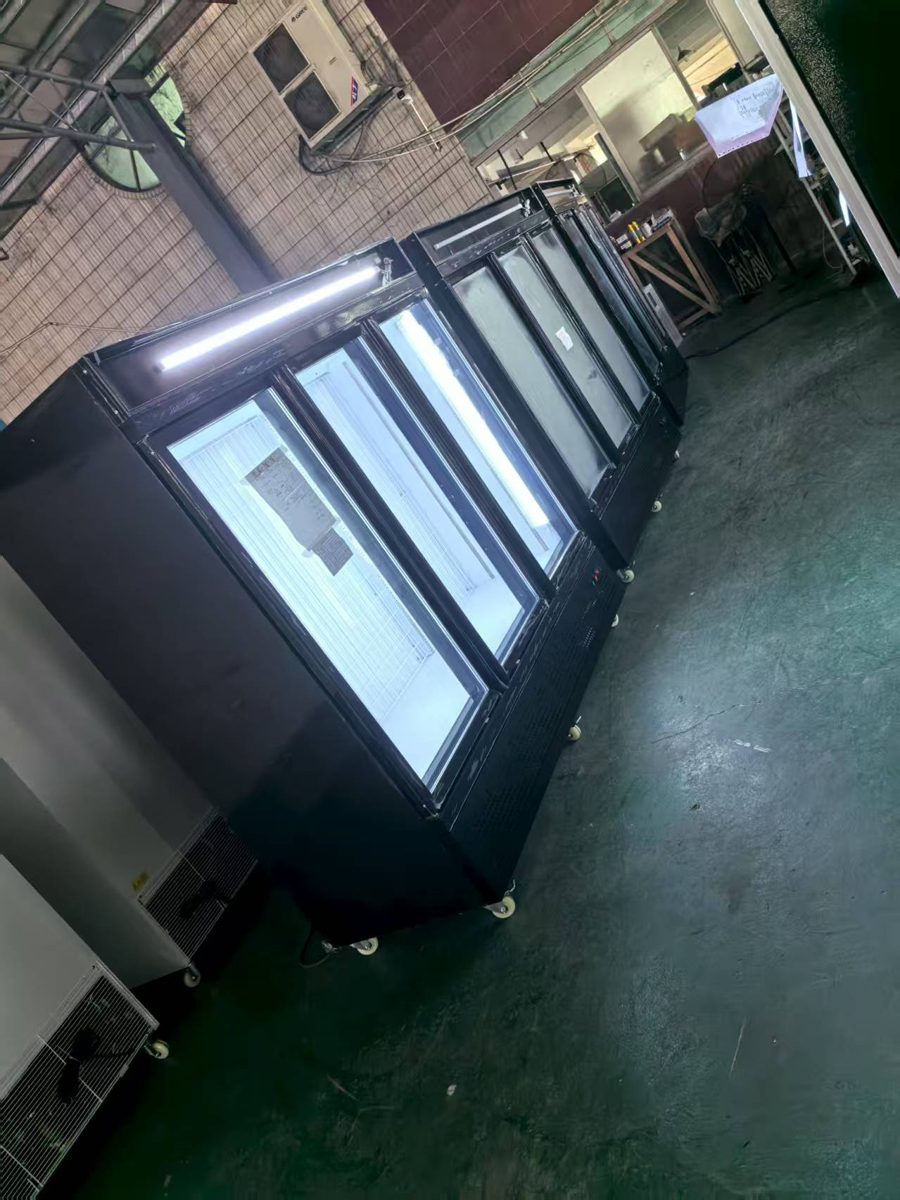 Row of glass-door display freezers under test